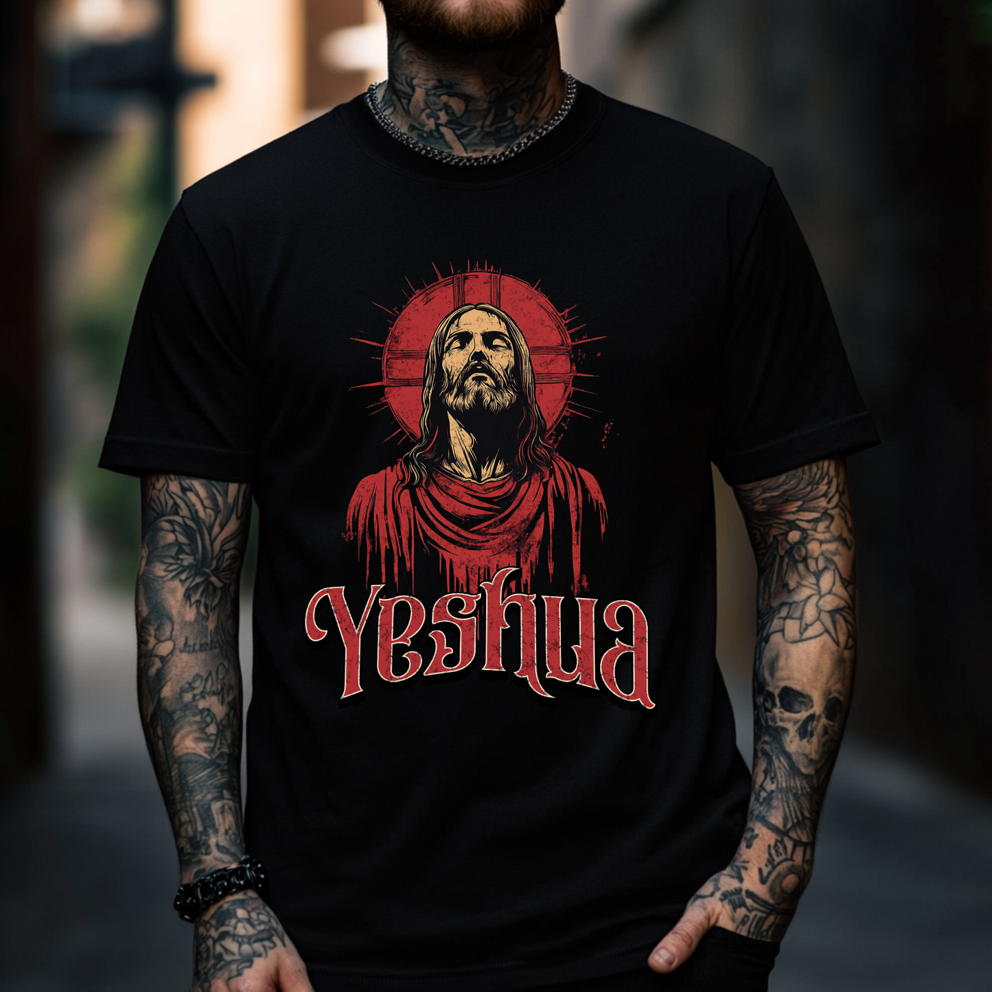 alternative tattooed man wearing a yeshua shirt that is black with short sleeves