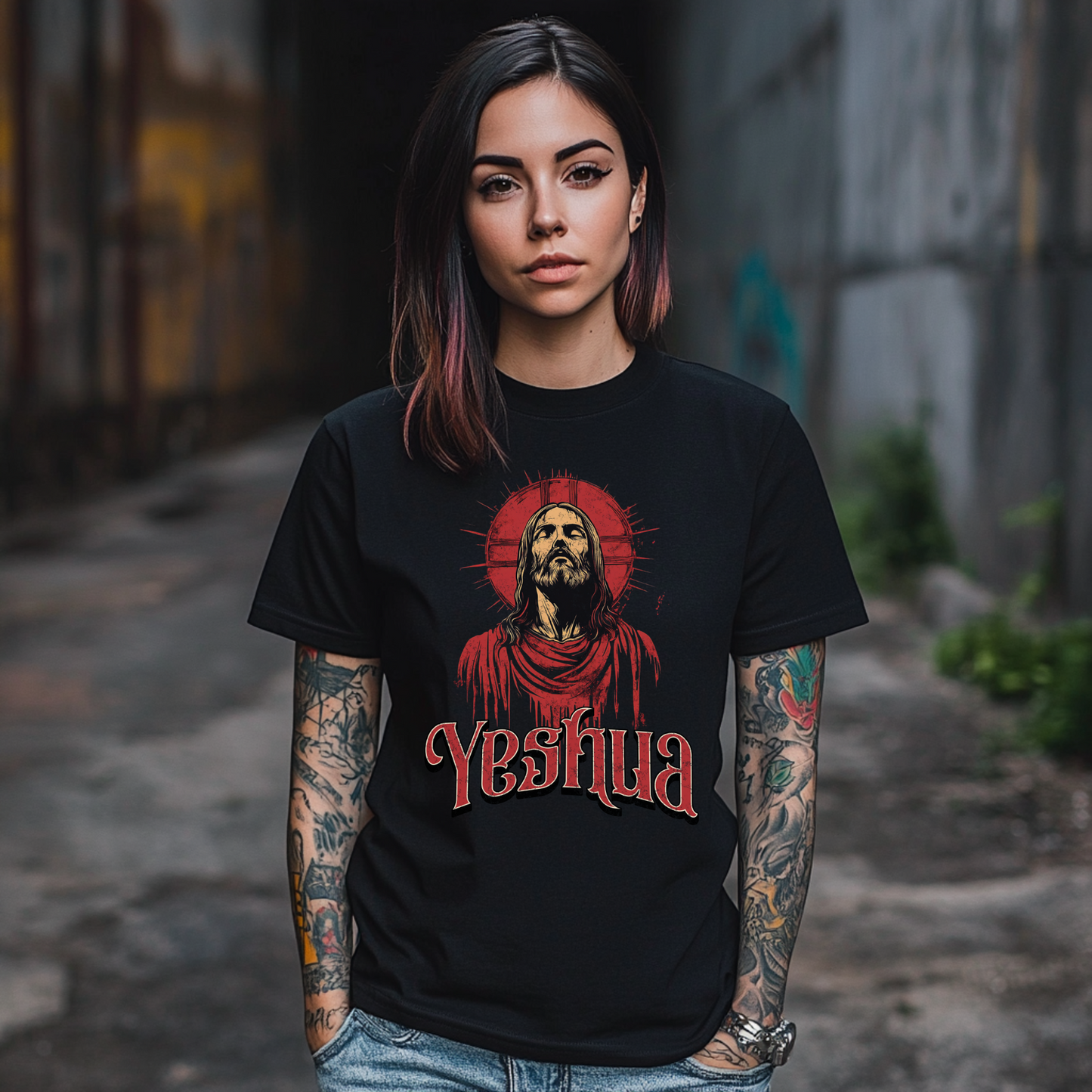 a tattooed woman wearing a cool christian shirt with the name Yeshua on it and a picture of Jesus