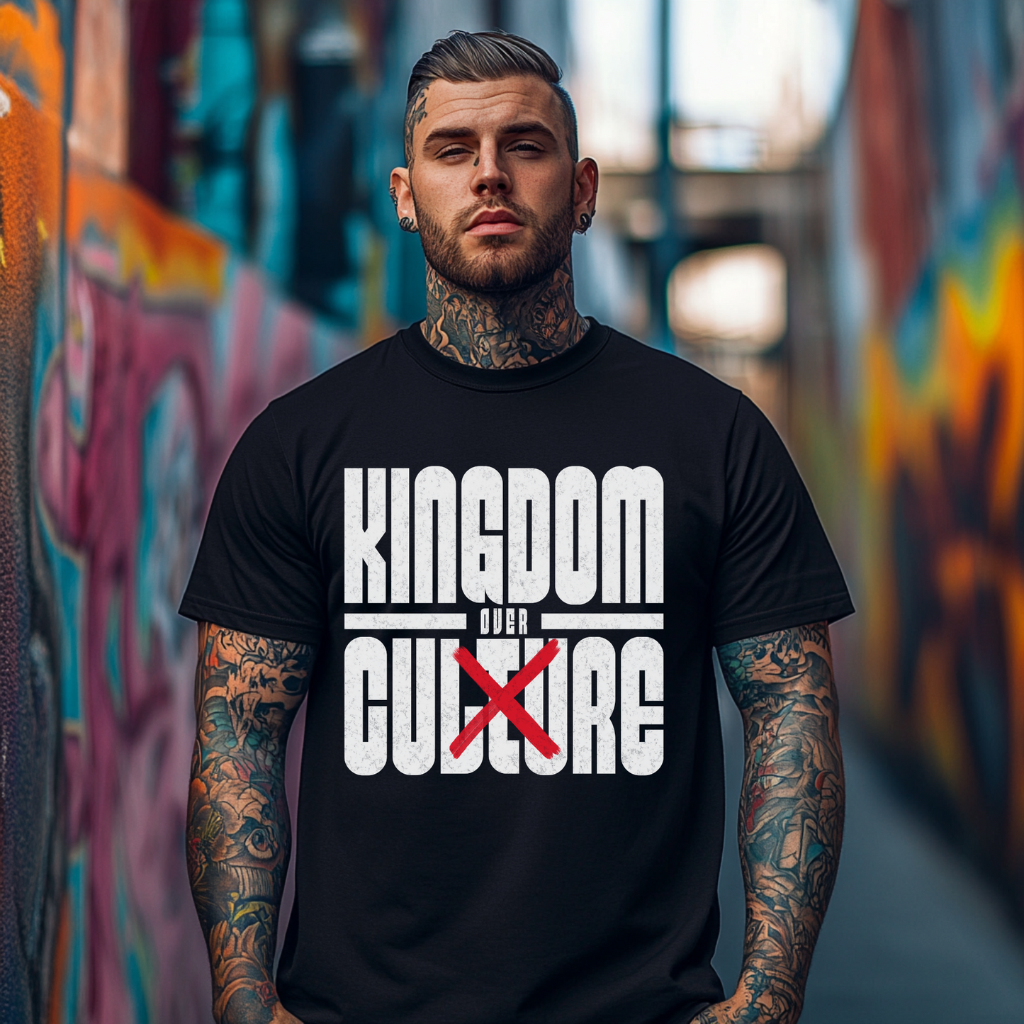 a tattooed man wearing a bold christian tshirt in black that says kingdom over culture in bold white lettering