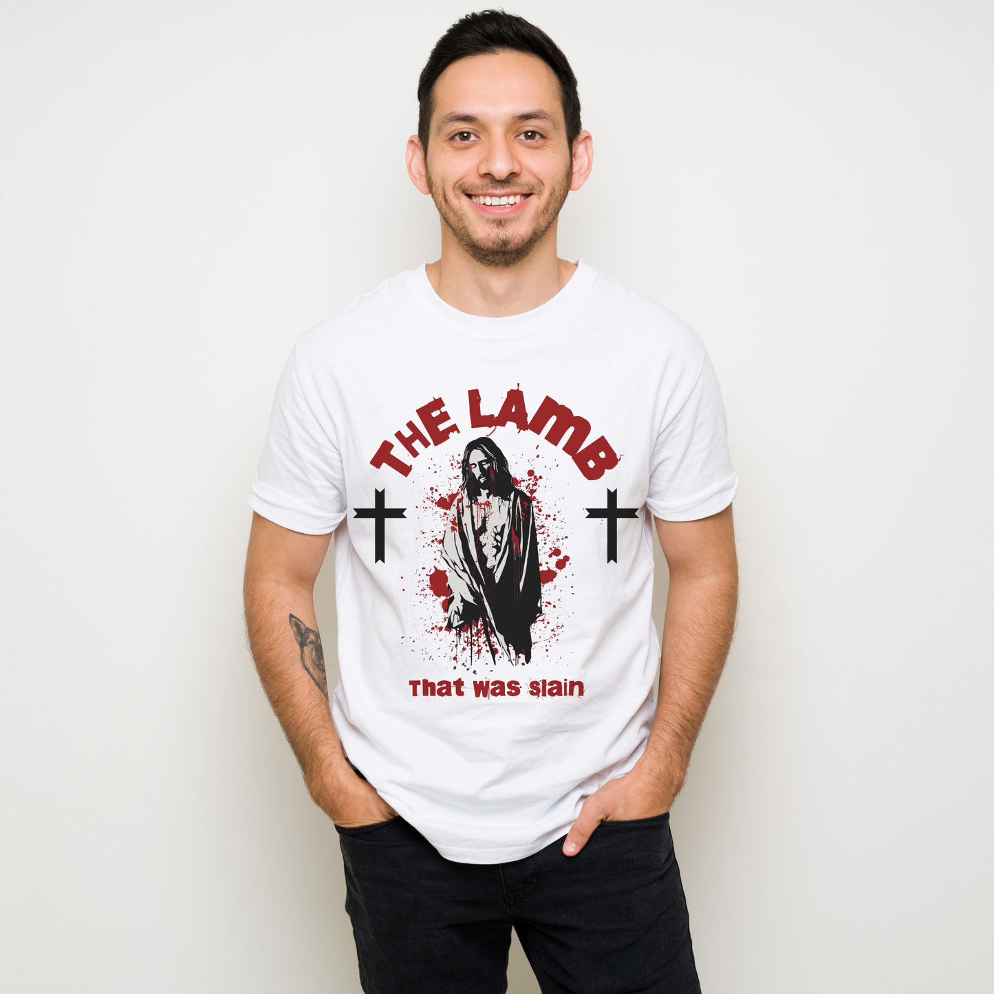 man wearing a white crew neck short sleeve alternative christian graphic tee that says the lamb that was slain with an image of jesus