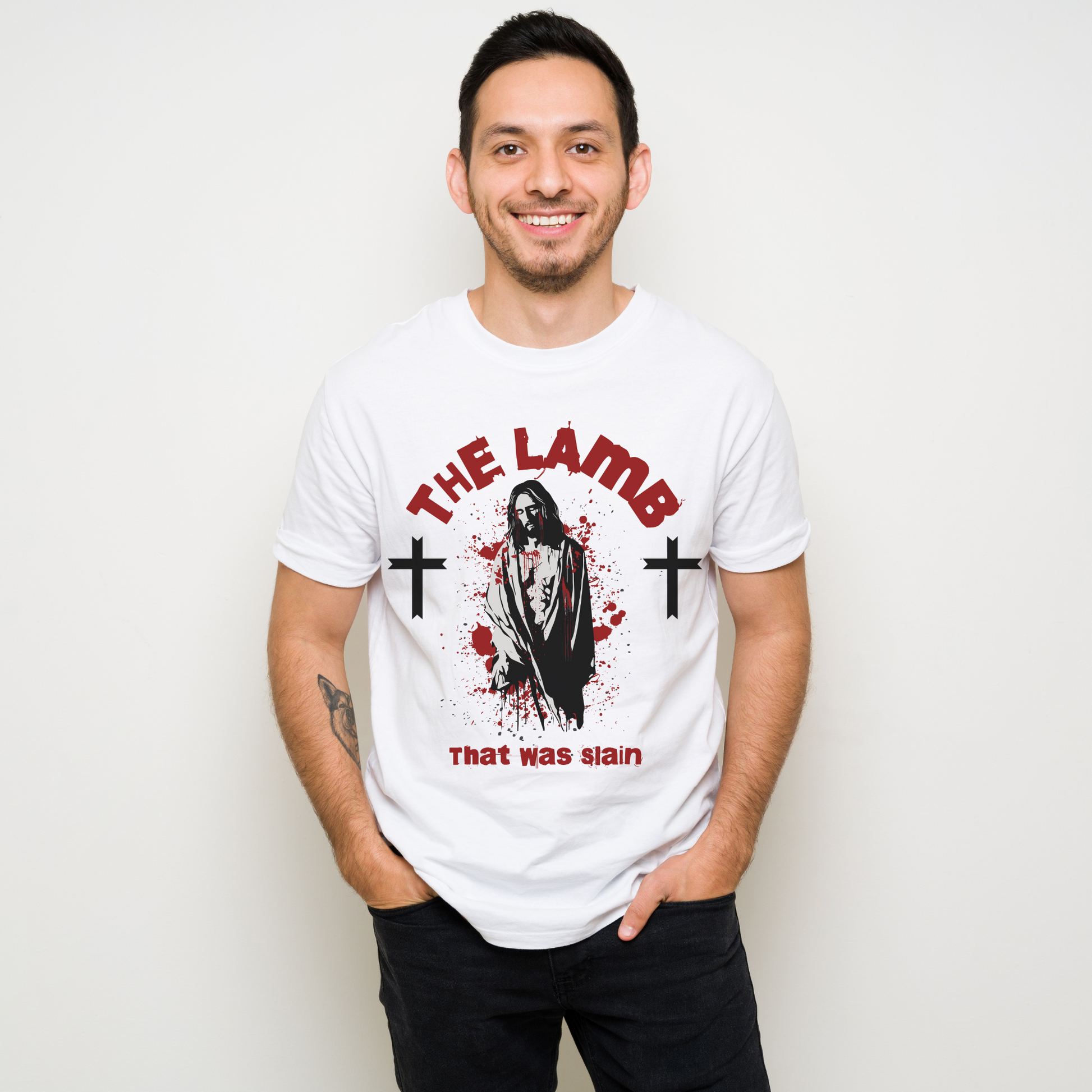 man wearing a white crew neck short sleeve alternative christian graphic tee that says the lamb that was slain with an image of jesus