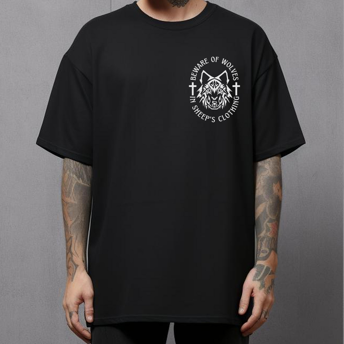 tattooed man wearing a crewneck short sleeve black christian streetwear graphic tee that says beware of wolves shirt