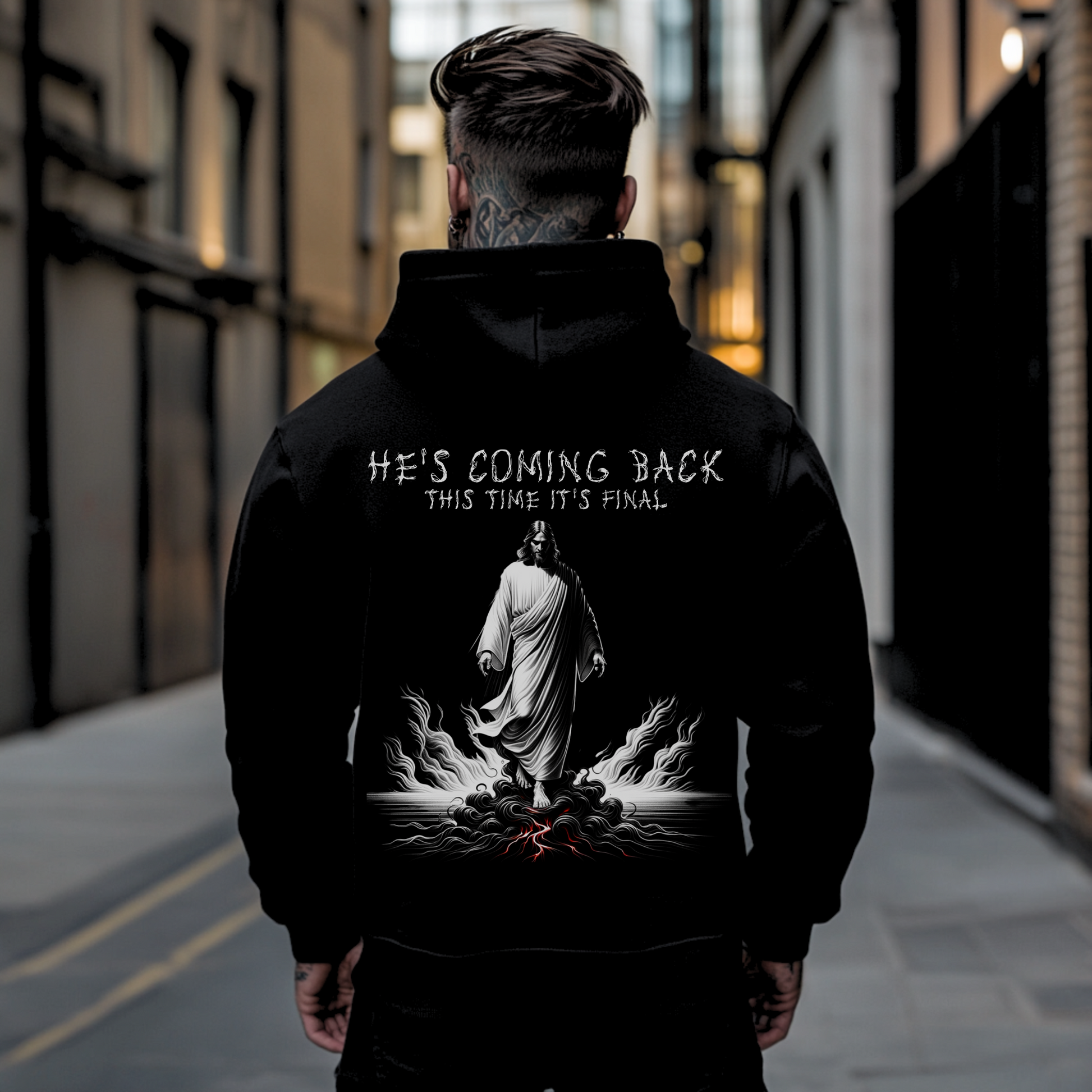 tattooed streetwear man with back facing camera showing backside of a christian hooded sweatshirt with an image of jesus 