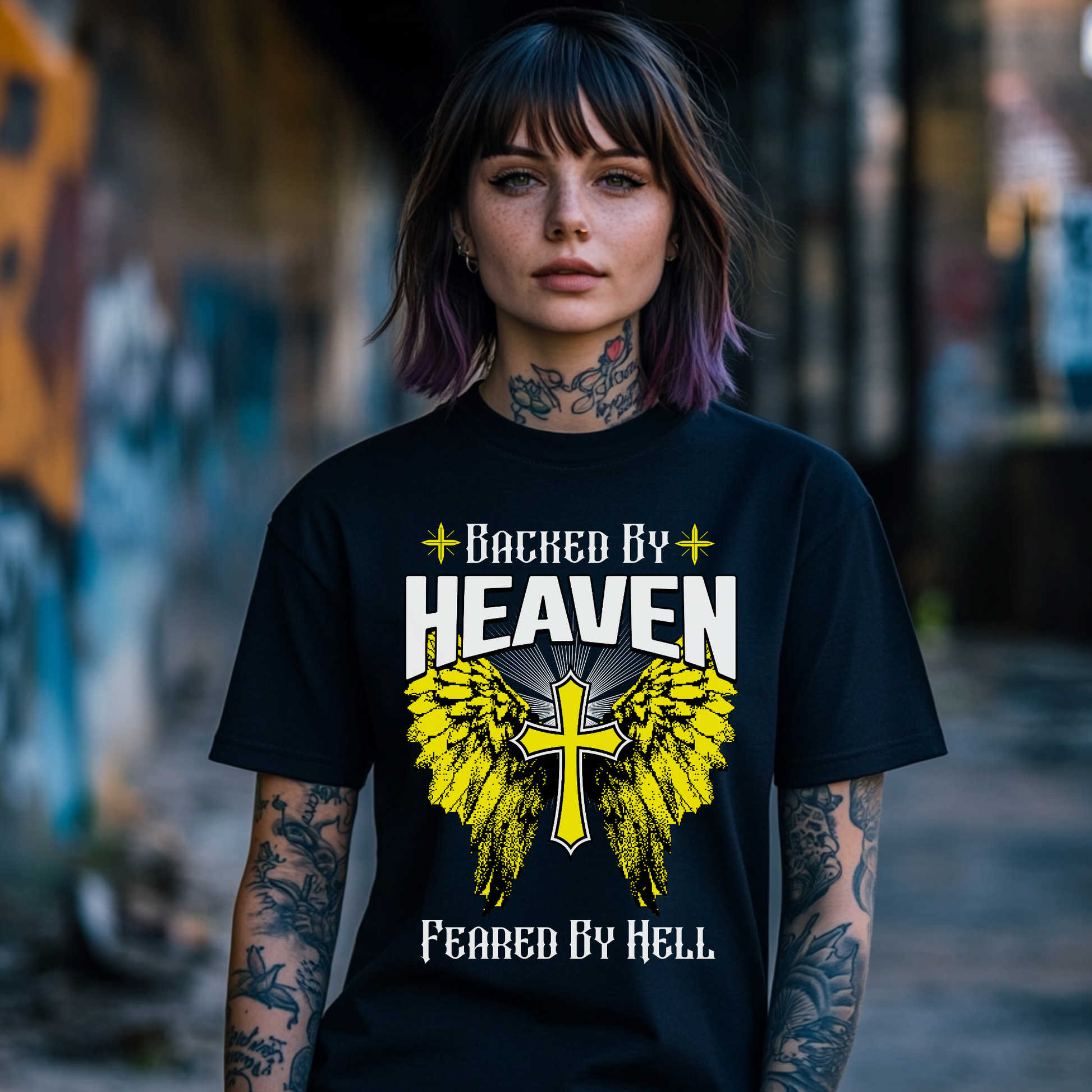 edgy christian tshirt, black crewneck short sleeve, backed by heaven feared by hell