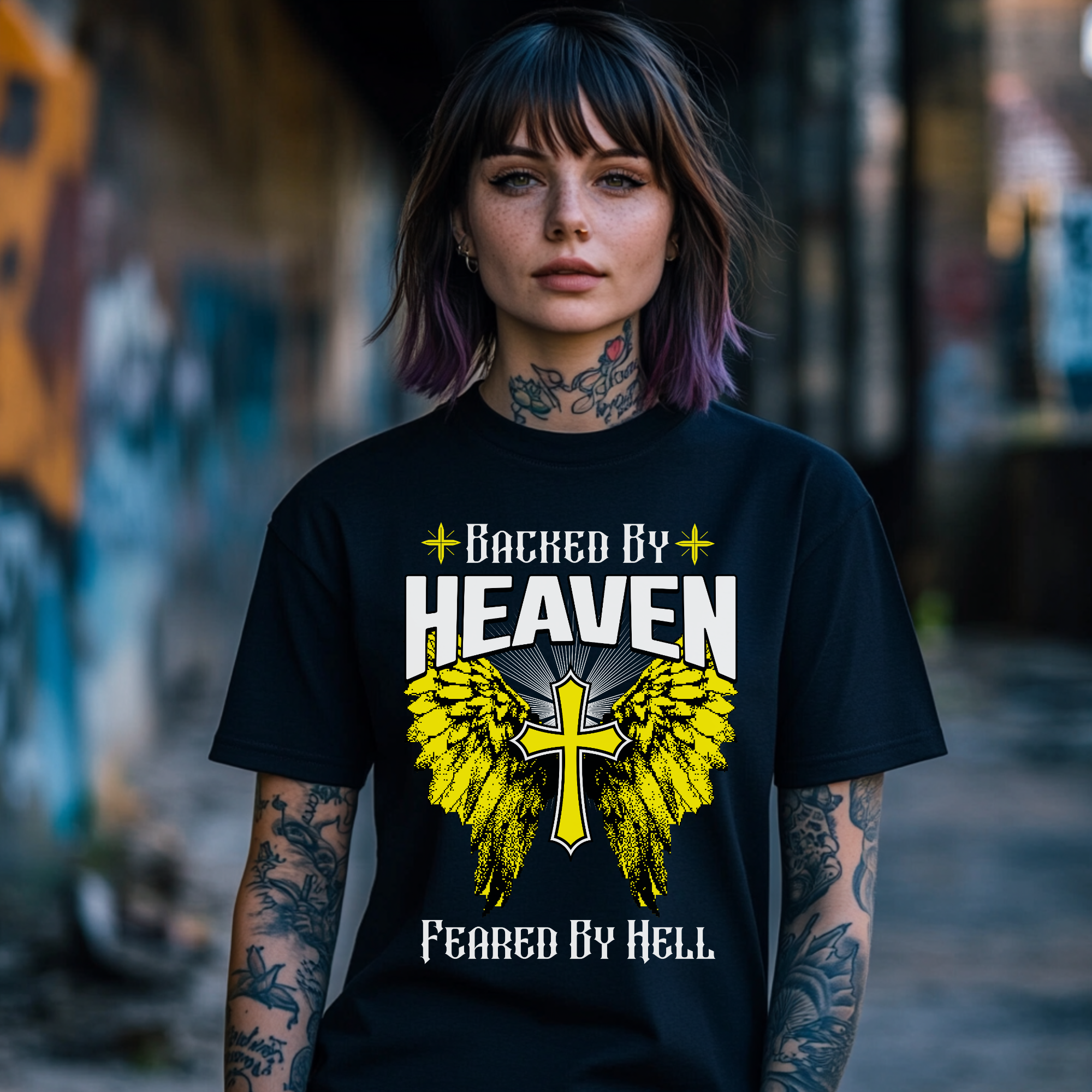 edgy christian tshirt, black crewneck short sleeve, backed by heaven feared by hell