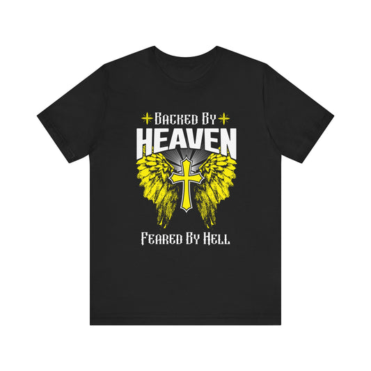 Black christian t-shirt with 'Backed by Heaven, Feared by Hell' design featuring a cross and wings flat laid on a white background.