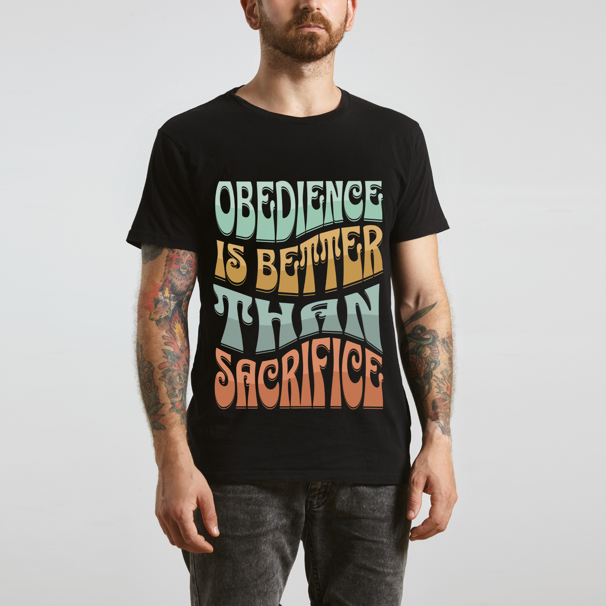 man wearing modern christian apparel in a black crew neck short sleeve graphic tee that says obedience is better than sacrifice bible verse shirt for men