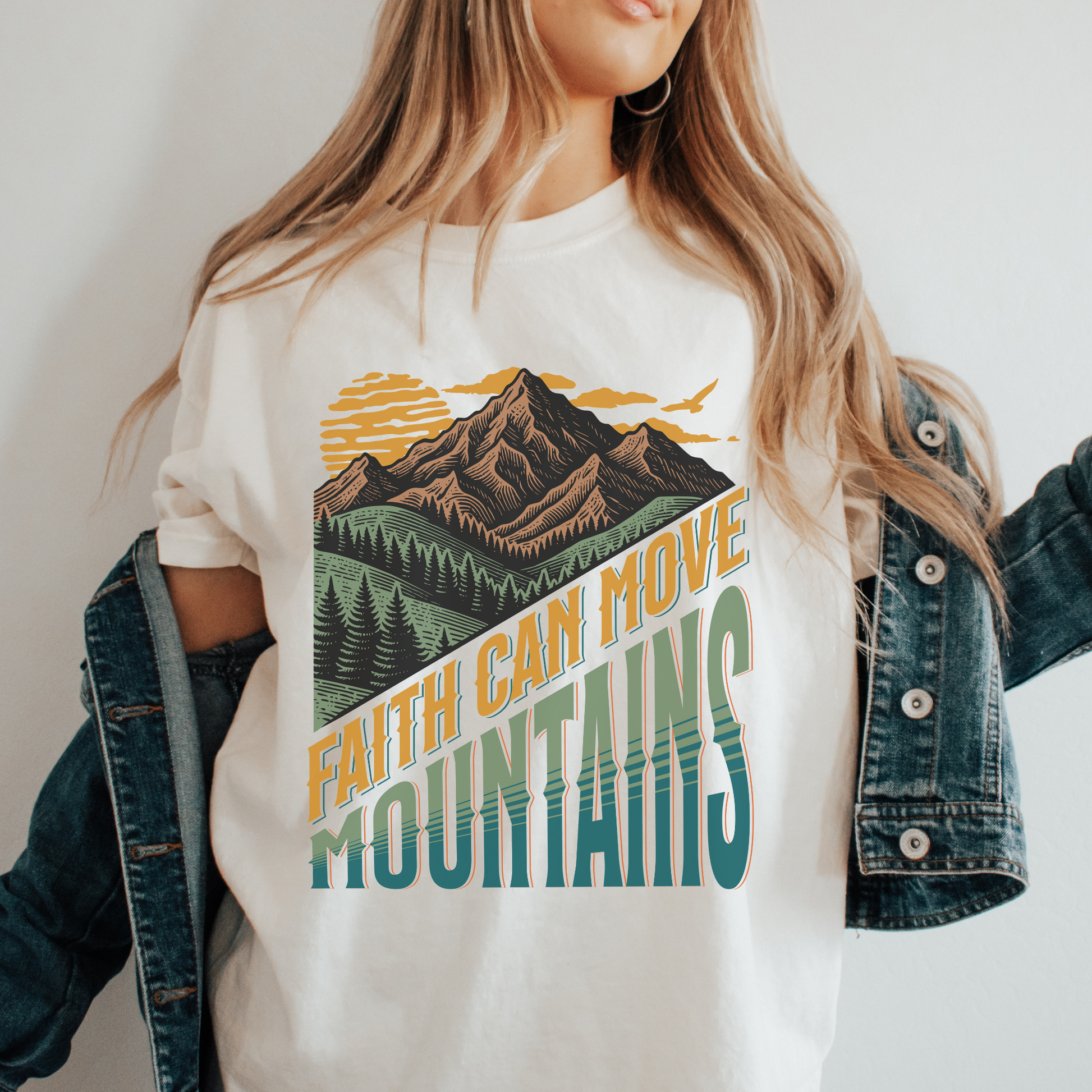 women wearing a faith can move mountains christian shirt with mountain landscape