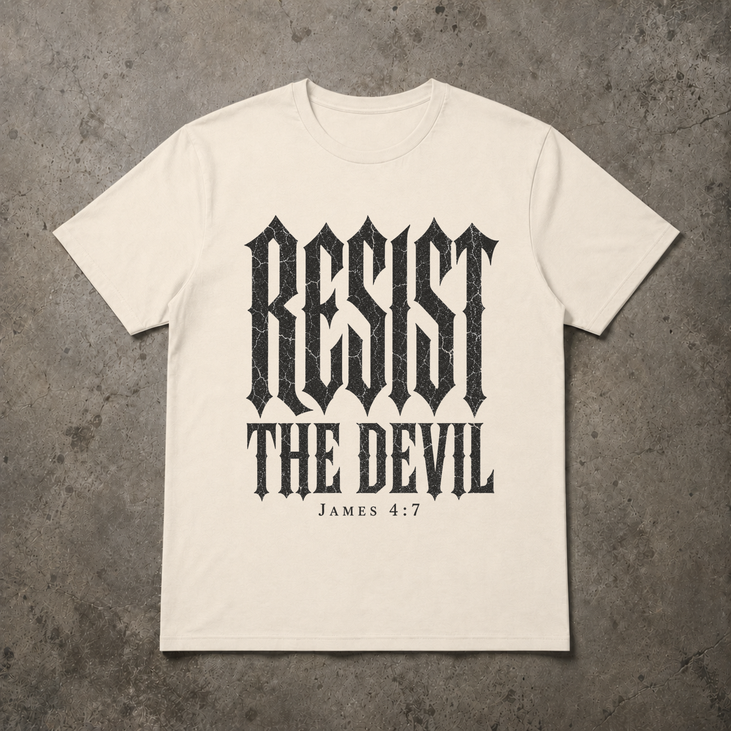 flat lay image of a natural ivory christian streetwear tshirt with black distressed gothic lettering RESIST THE DEVIL