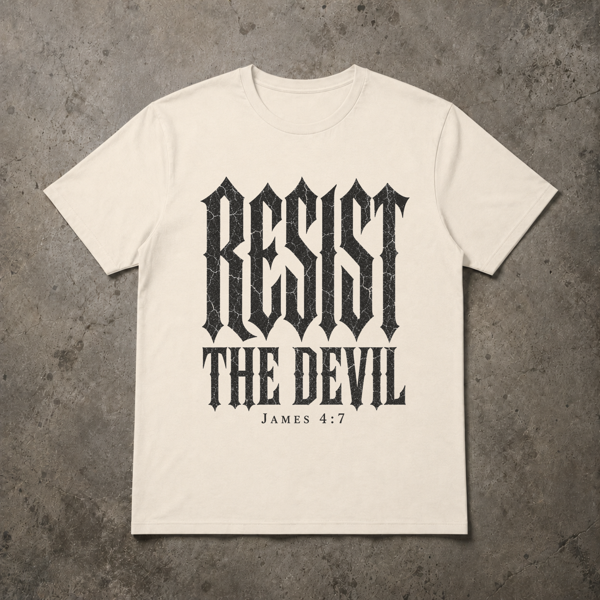 flat lay image of a natural ivory christian streetwear tshirt with black distressed gothic lettering RESIST THE DEVIL