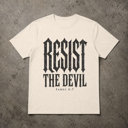 flat lay image of a natural ivory christian streetwear tshirt with black distressed gothic lettering RESIST THE DEVIL