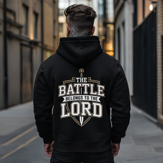 back side of a black spiritual warfare christian hoodie that says The Battle Belongs To The Lord